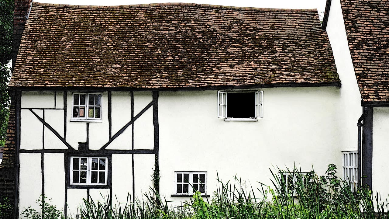 English village cottage with rendered walls and a pitched tiled roof